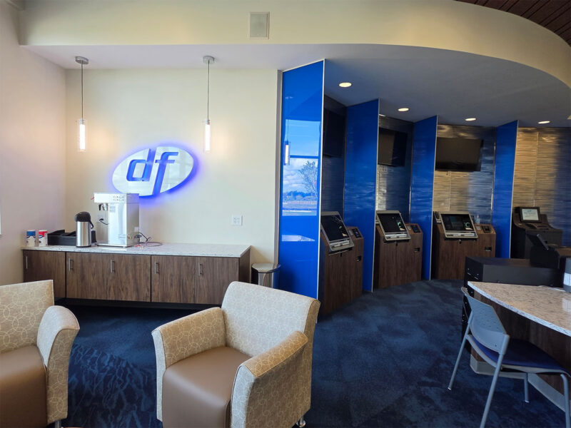Hospitality counter and blue logo inside Dort Financial’s Commerce Township Member Center