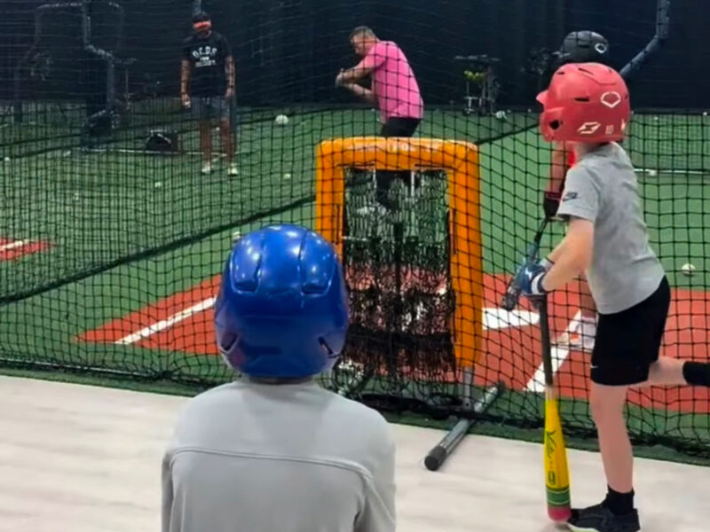 Young baseball players practicing in batting cages at Inge Performance Lab
