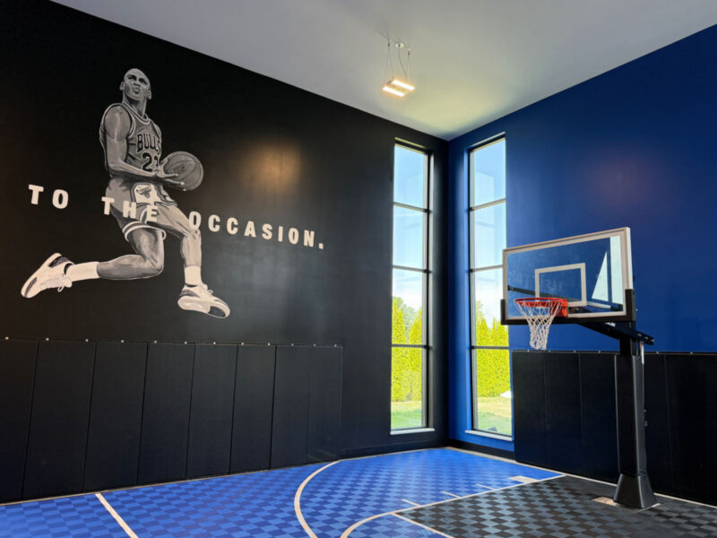 Indoor basketball hoop and athlete mural at R1SE in Frankenmuth