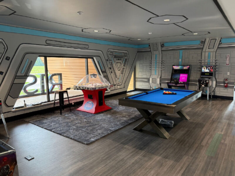 Game room with pool table and large windows at R1SE in Frankenmuth